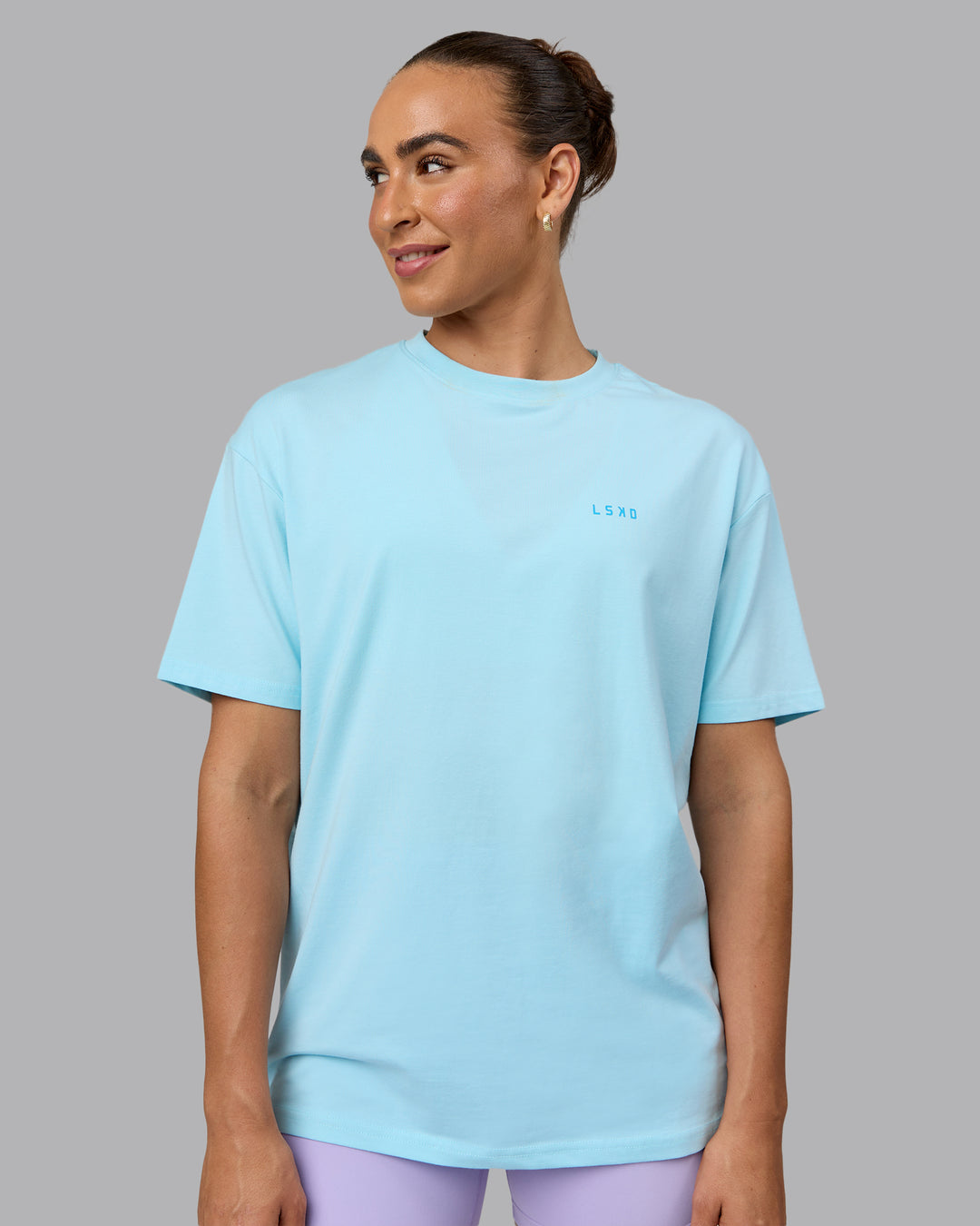 Woman wearing Unisex Enjoy the Journey Value Series FLXCotton Tee Oversize - Crystal Blue-Bay Blue