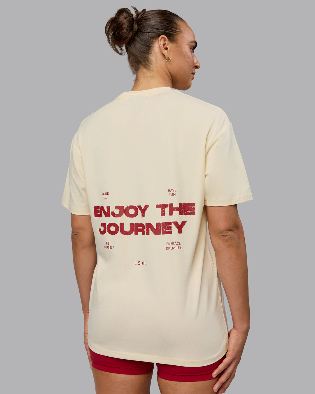 Woman wearing Unisex Enjoy the Journey Value Series FLXCotton Tee Oversize - Ivory-Cherry Red