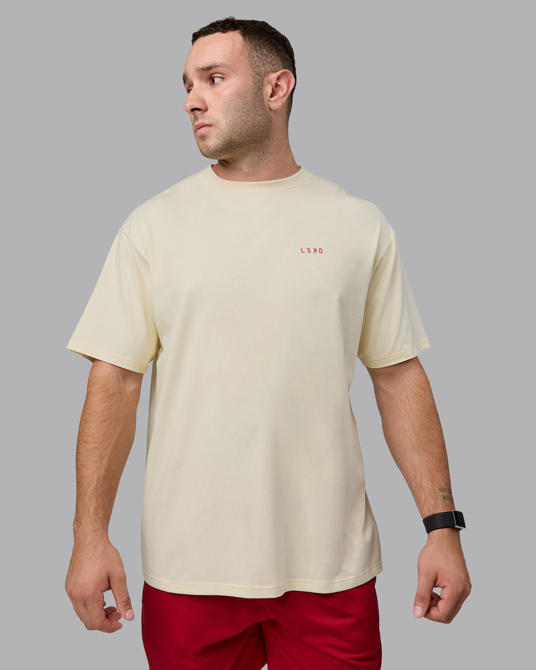 Man wearing Unisex Enjoy the Journey Value Series FLXCotton Tee Oversize - Ivory-Cherry Red