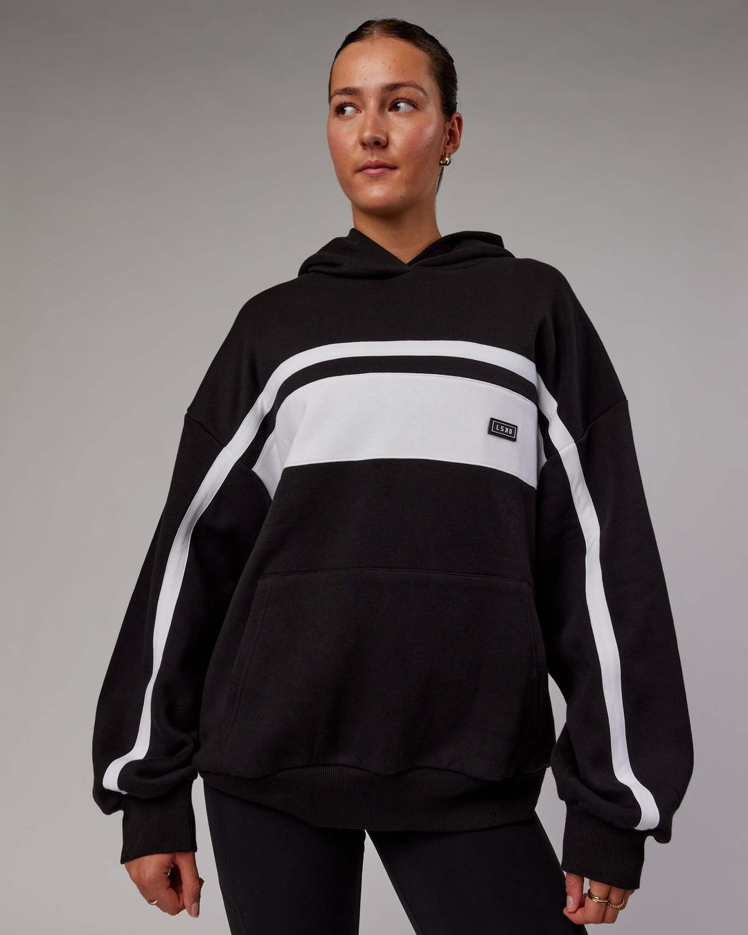 Woman wearing Unisex Intercept Hoodie Oversize - Black-White