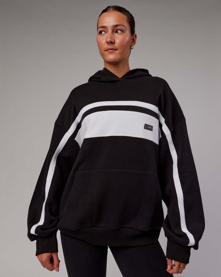 Woman wearing Unisex Intercept Hoodie Oversize - Black-White
