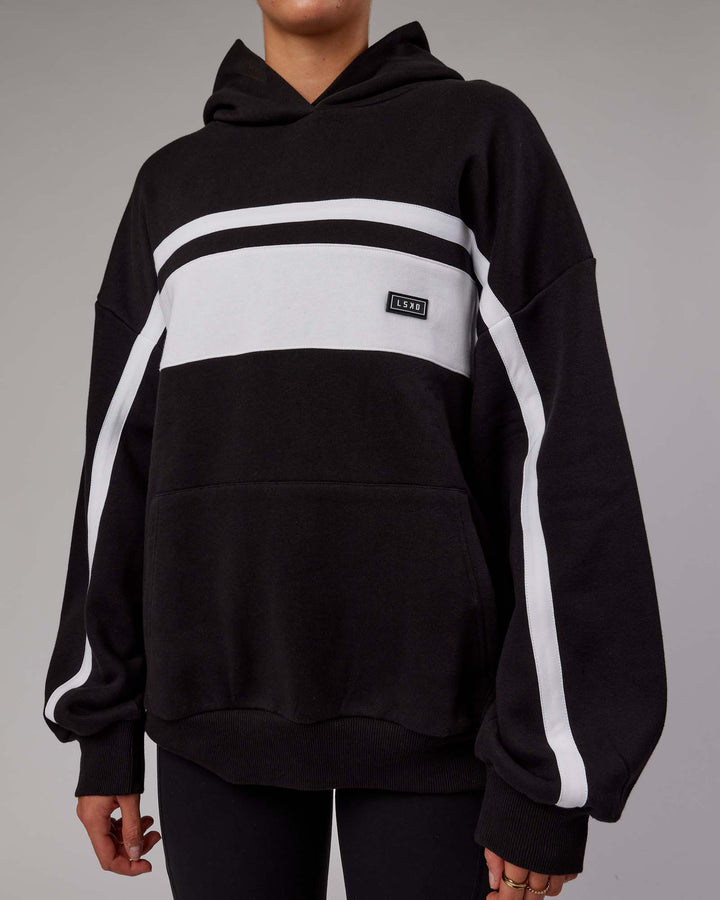 Woman wearing Unisex Intercept Hoodie Oversize - Black-White
