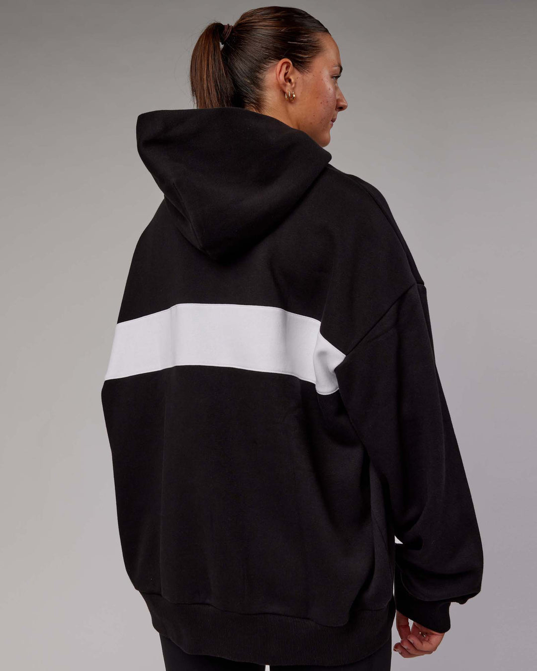 Woman wearing Unisex Intercept Hoodie Oversize - Black-White