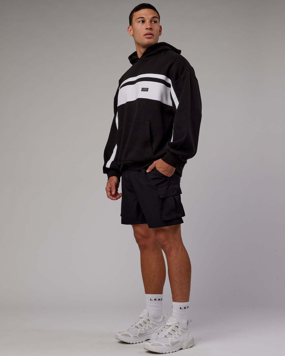 Man wearing Unisex Intercept Hoodie Oversize - Black-White