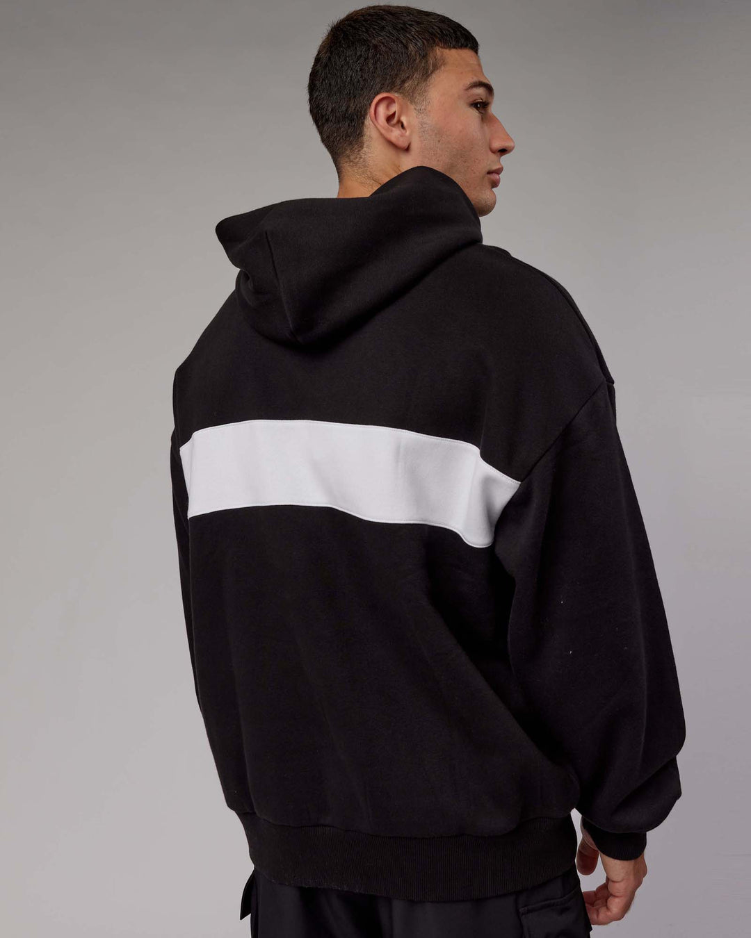 Man wearing Unisex Intercept Hoodie Oversize - Black-White