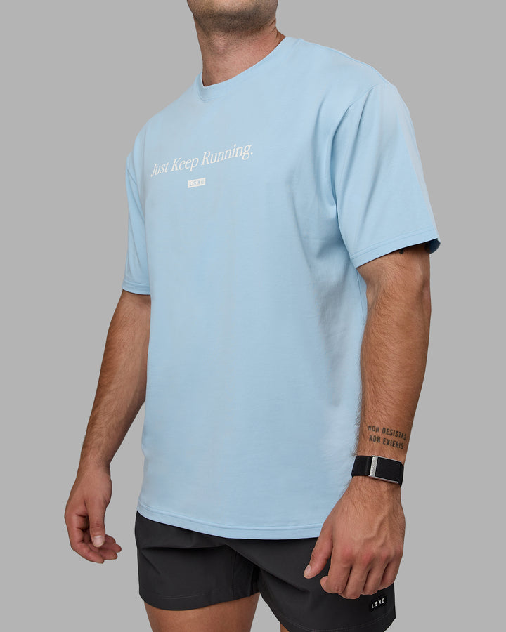 Man wearing Unisex Just Keep Running FLXCotton Tee Oversize - Glacial Blue-Off White
