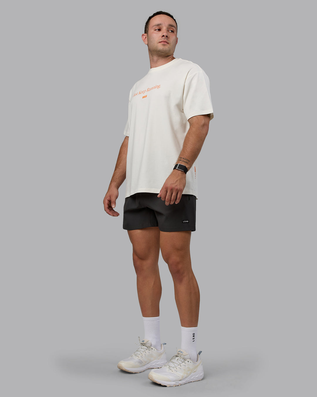 Man wearing Unisex Just Keep Running FLXCotton Tee Oversize - Off White-Vibrant Orange