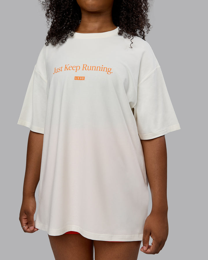 Woman wearing Unisex Just Keep Running FLXCotton Tee Oversize - Off White-Vibrant Orange
