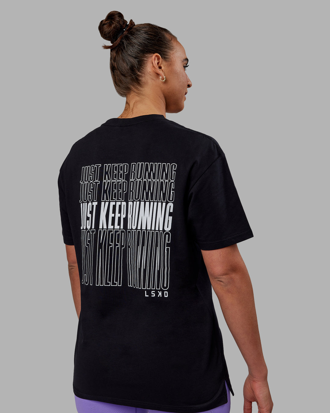 Woman wearing Unisex Keep On Running FLXCotton Oversize Tee - Black-White