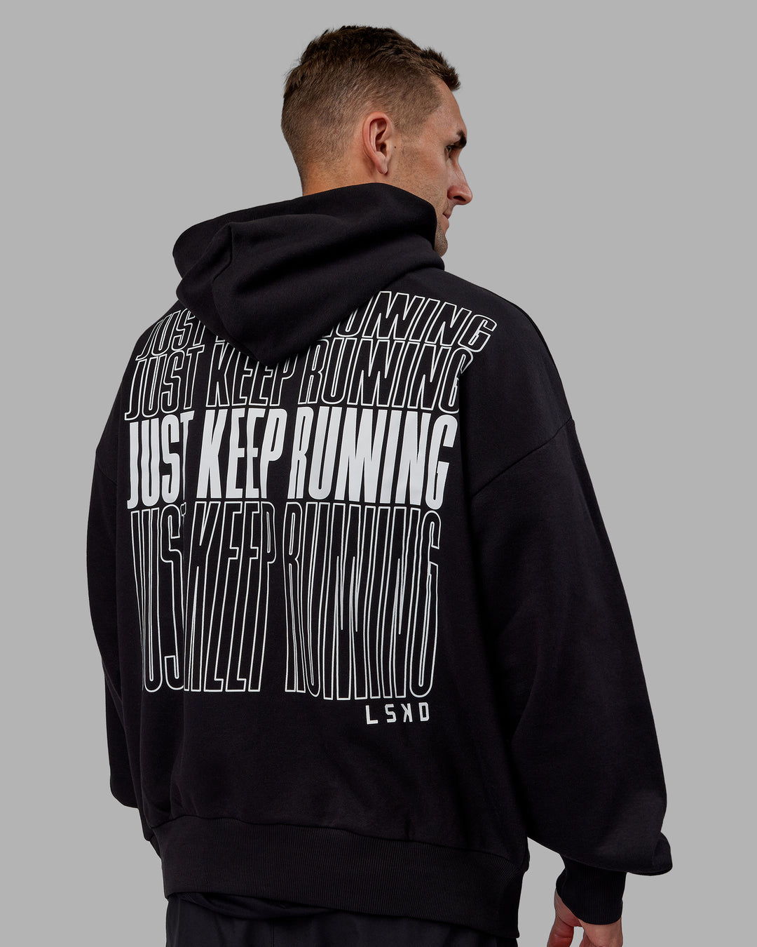 Man wearing Unisex Keep on Running Hoodie Oversize - Black-White