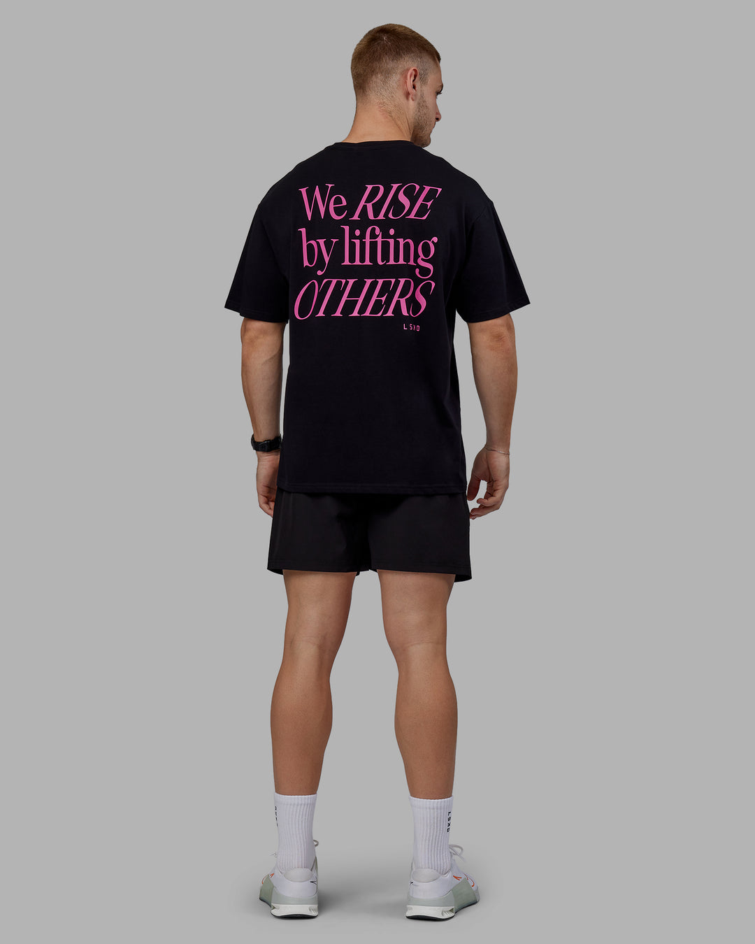 Man wearing Unisex Lift-Up FLXCotton Tee Oversize - Black-Fuschia Pink