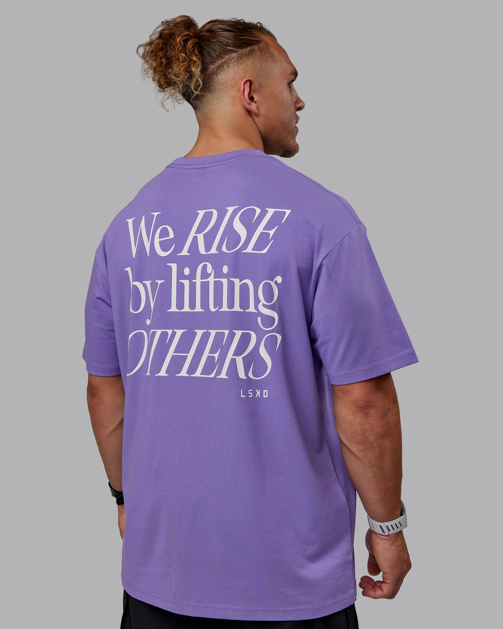 Man wearing Unisex Lift-Up FLXCotton Tee Oversize - Dahlia Purple