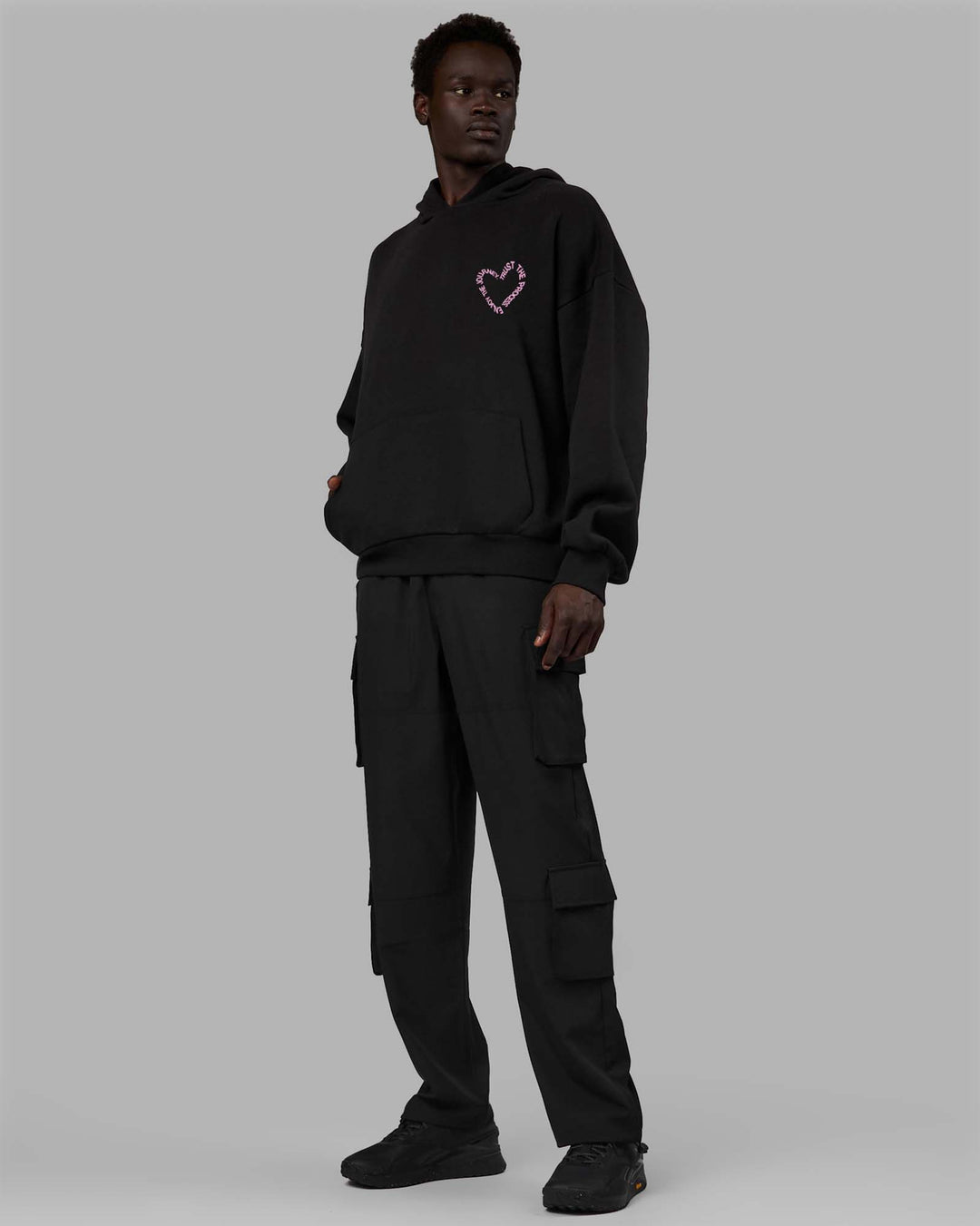 Man wearing Unisex Love The Process Oversize Hoodie - Black-Bubble Gum