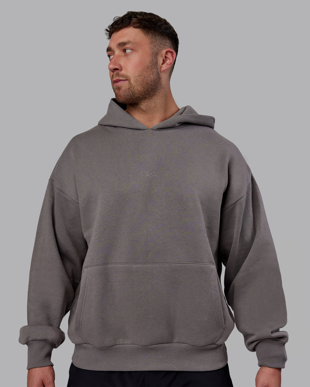 Man wearing Unisex MVP Hoodie Oversize - Storm Front