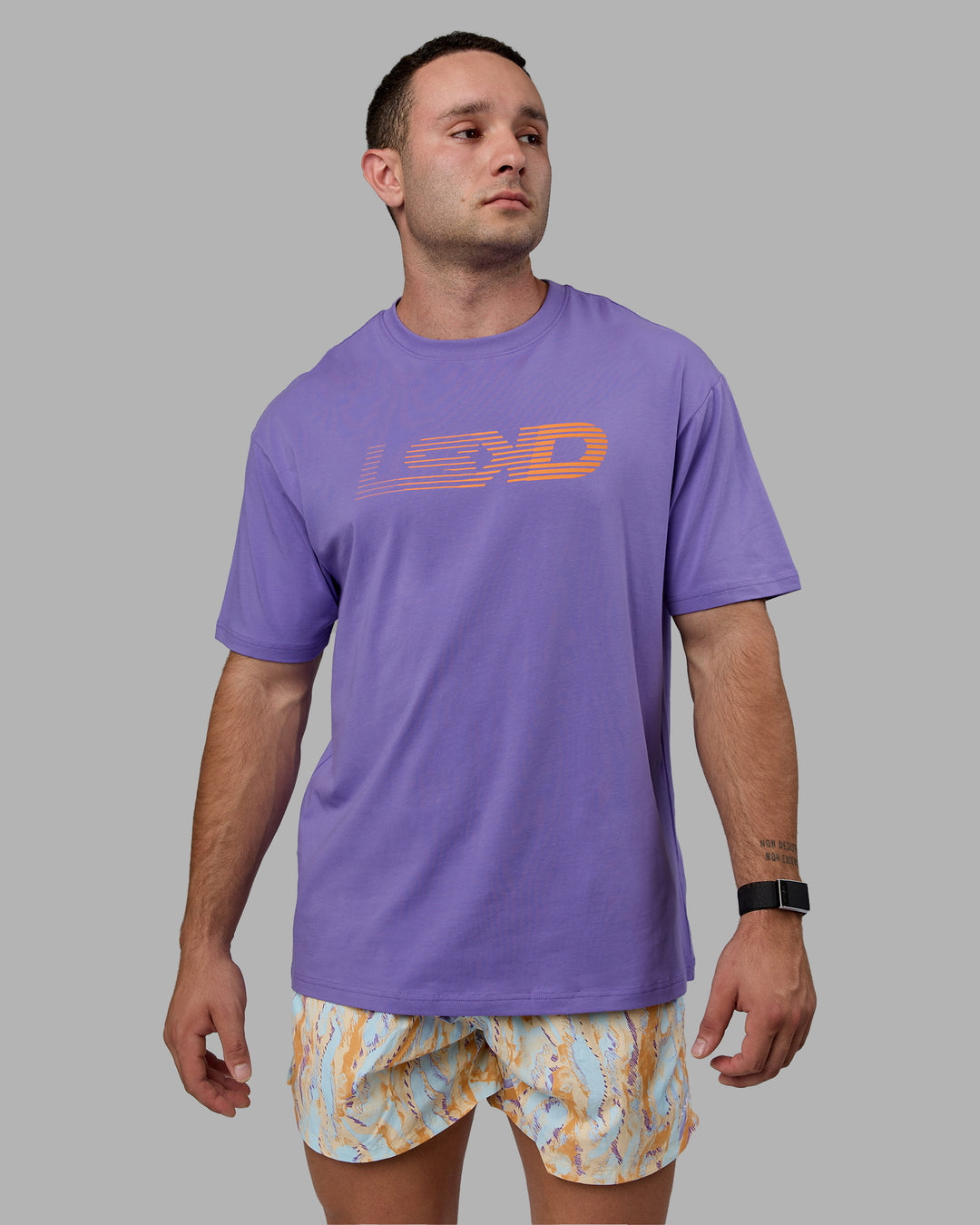 Man wearing Unisex Motion FLXCotton Tee Oversize - Dahlia Purple-Vibrant Orange