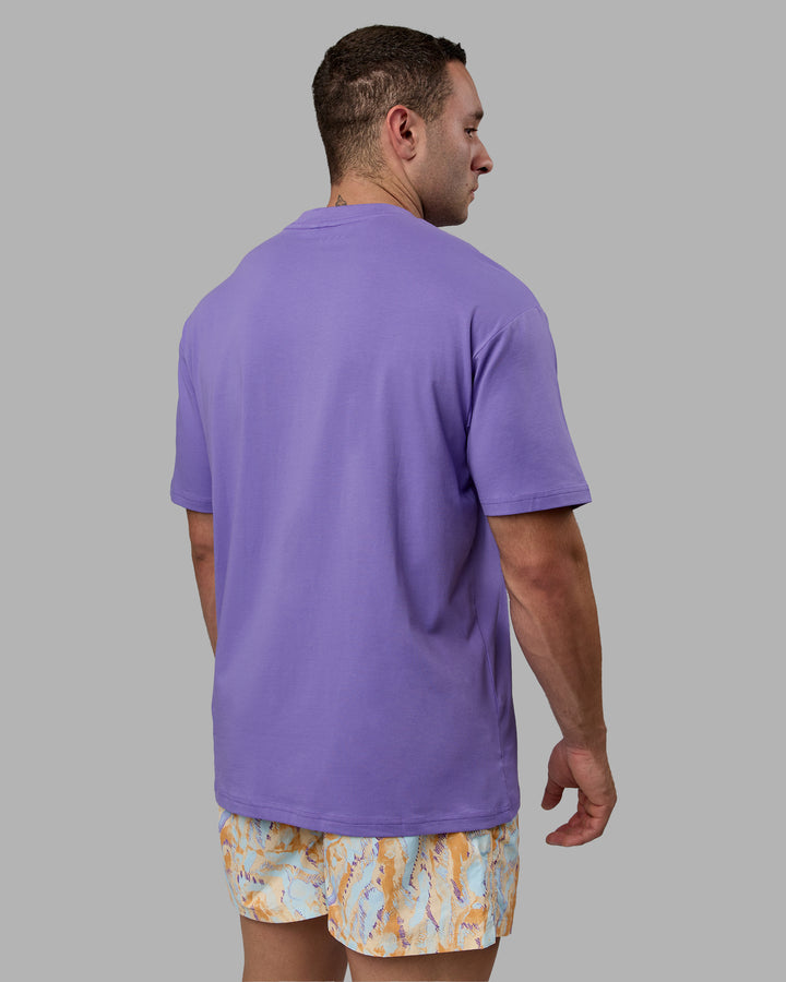 Man wearing Unisex Motion FLXCotton Tee Oversize - Dahlia Purple-Vibrant Orange
