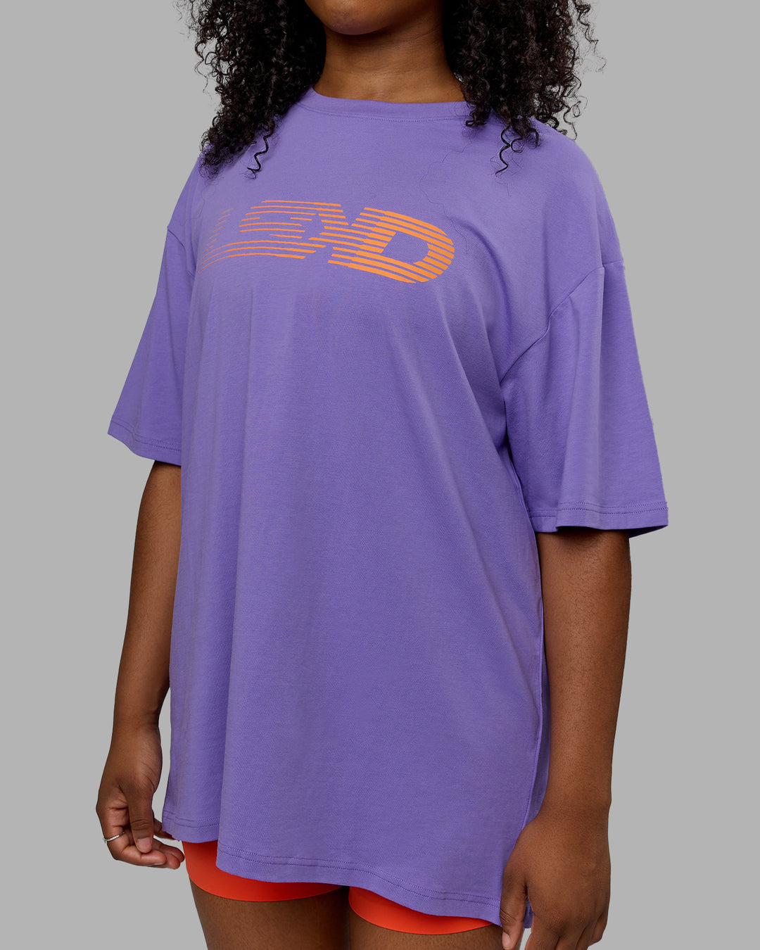 Woman wearing Unisex Motion FLXCotton Tee Oversize - Dahlia Purple-Vibrant Orange