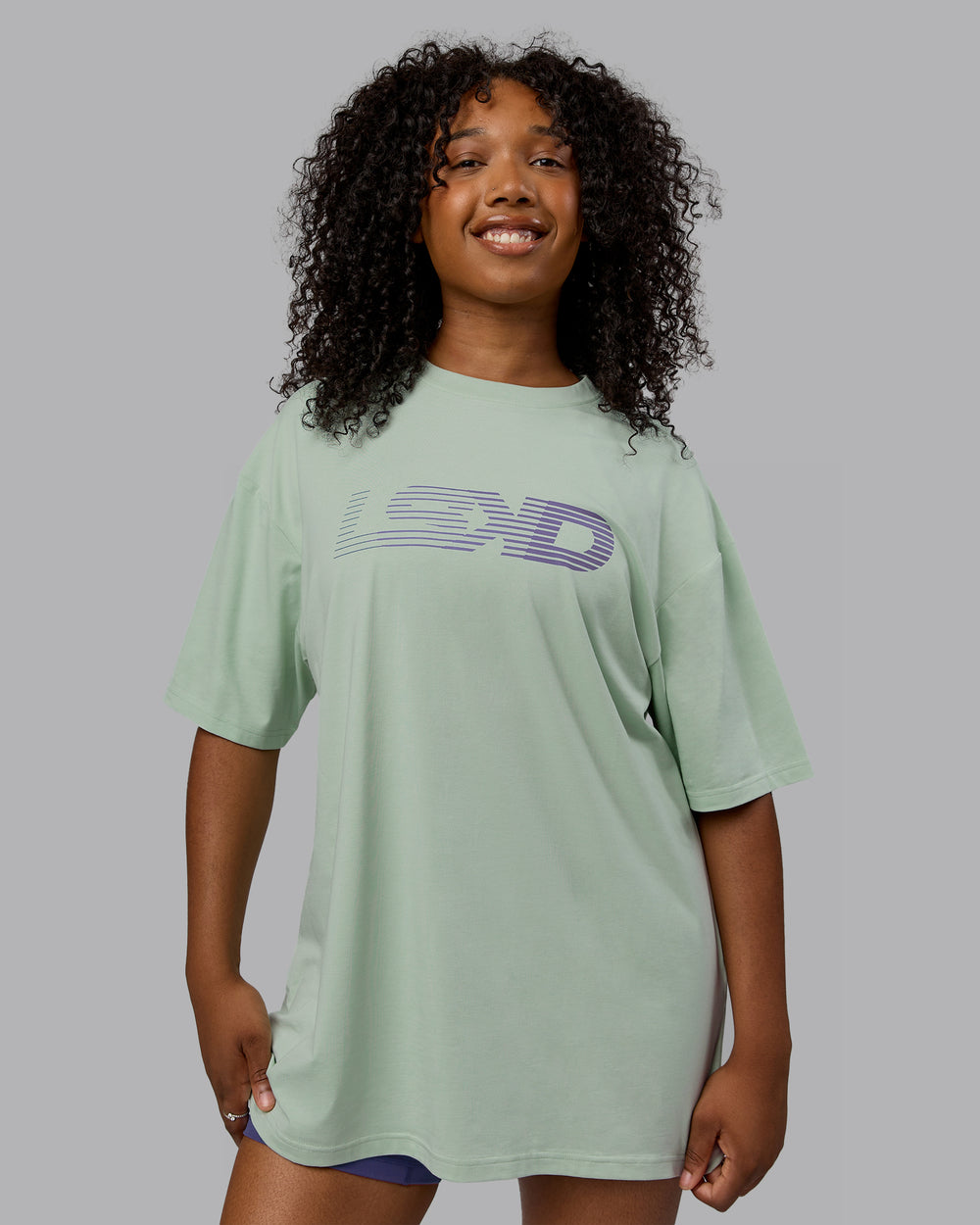 Woman wearing Unisex Motion FLXCotton Tee Oversize - Surf Spray-Royal Purple