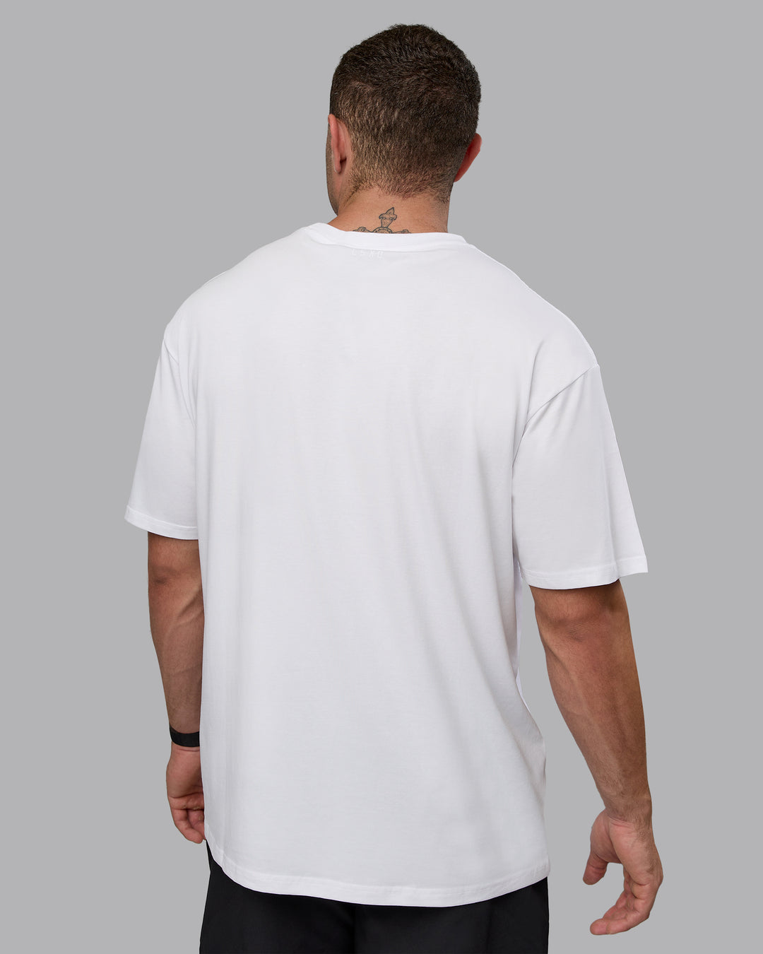 Man wearing Unisex Motion FLXCotton Tee Oversize - White-React Print