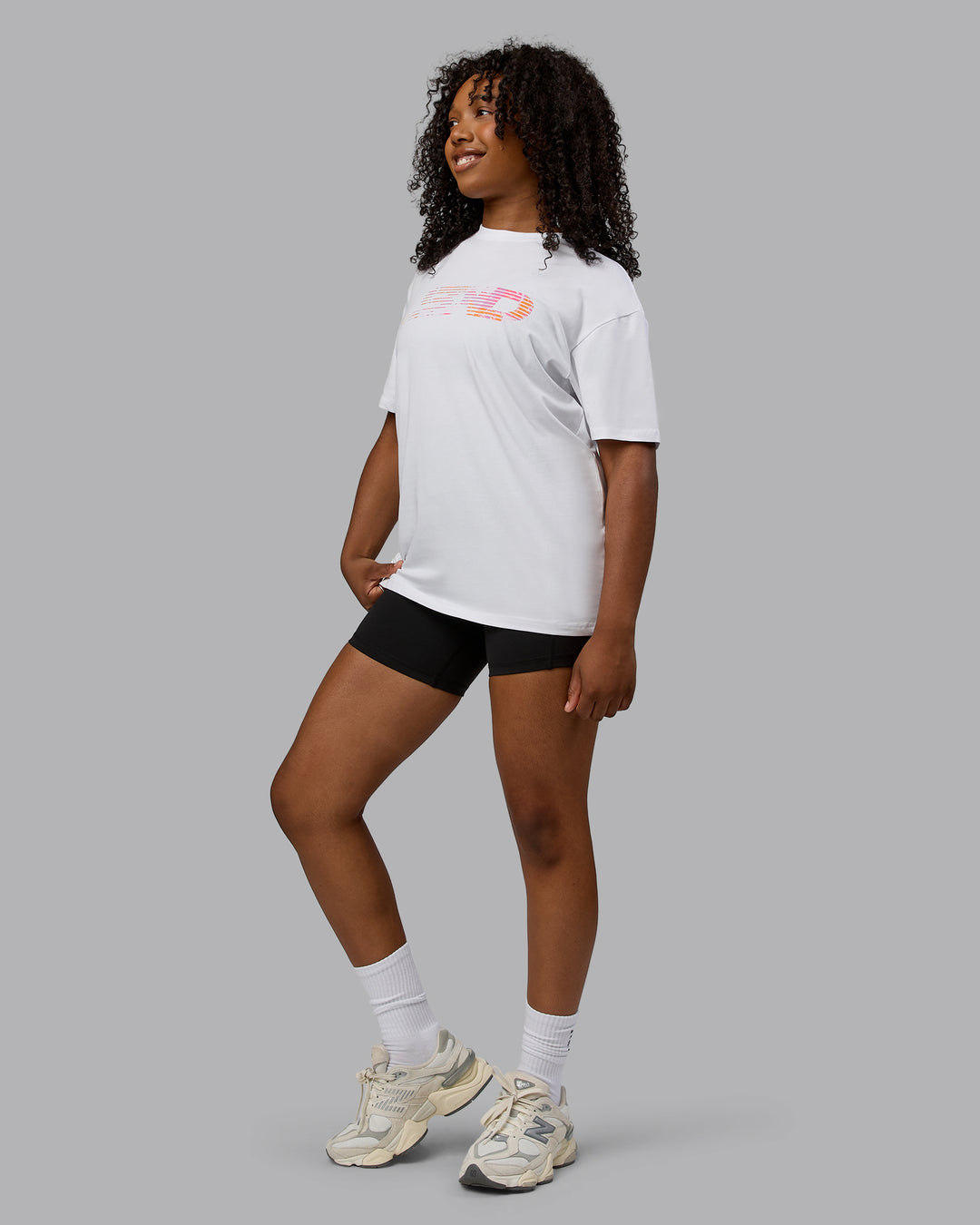 Woman wearing Unisex Motion FLXCotton Tee Oversize - White-React Print