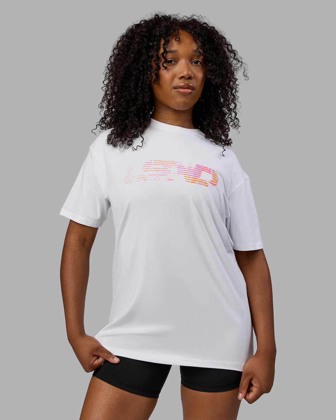 Woman wearing Unisex Motion FLXCotton Tee Oversize - White-React Print