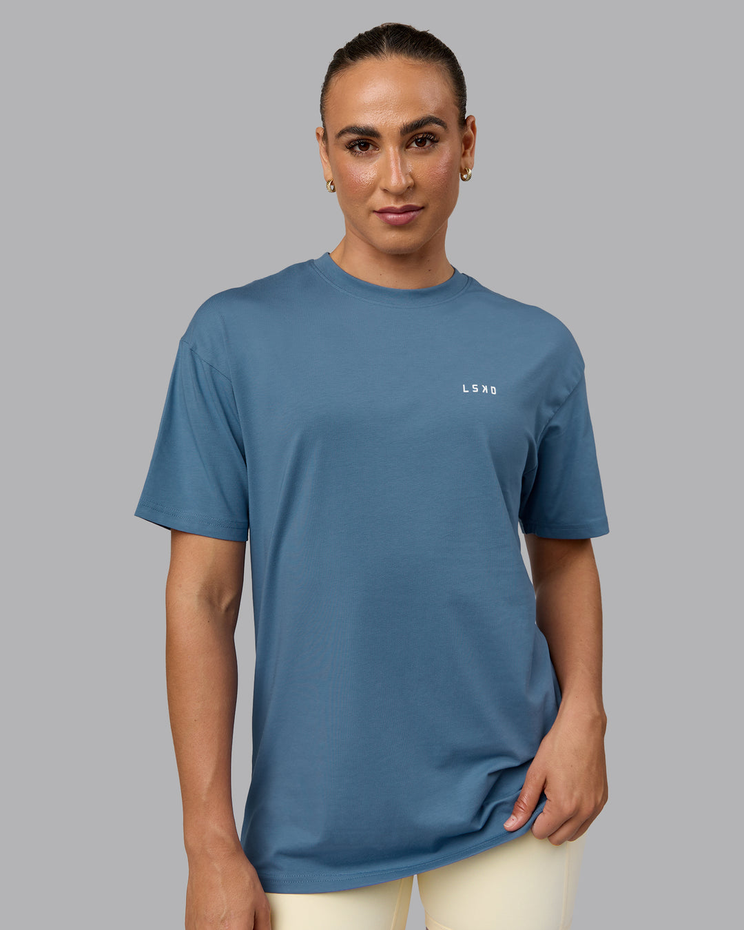 Woman wearing Unisex Move Fast Value Series FLXCotton Tee Oversize - Elemental Blue-Off White