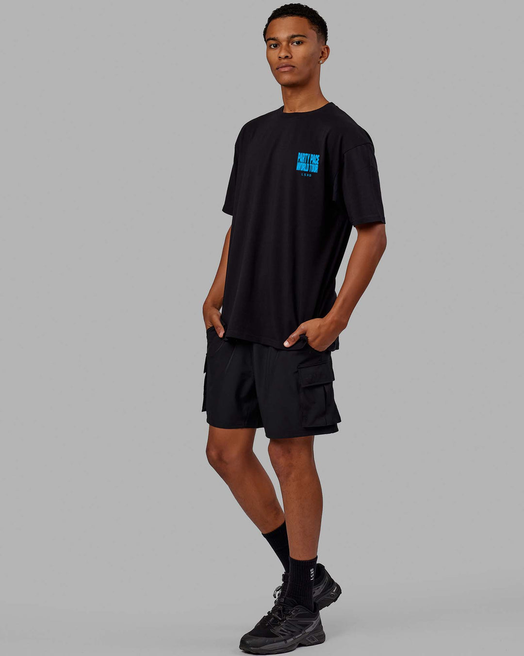 Man wearing Unisex Party Pace FLXCotton Oversize Tee - Black-Blue  Edit alt text