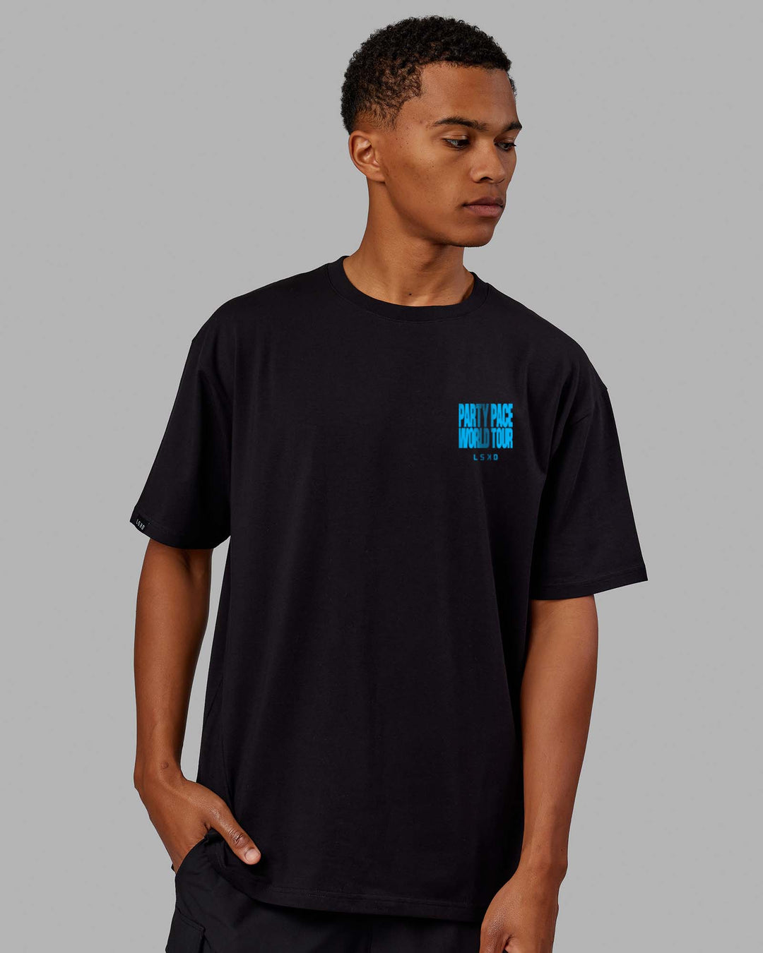 Man wearing Unisex Party Pace FLXCotton Oversize Tee - Black-Blue  Edit alt text