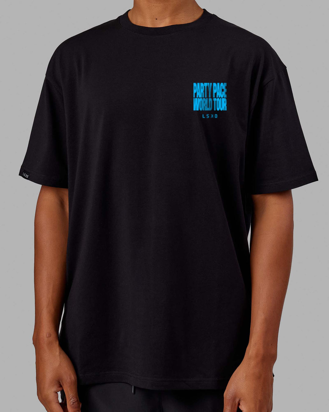 Man wearing Unisex Party Pace FLXCotton Oversize Tee - Black-Blue  Edit alt text