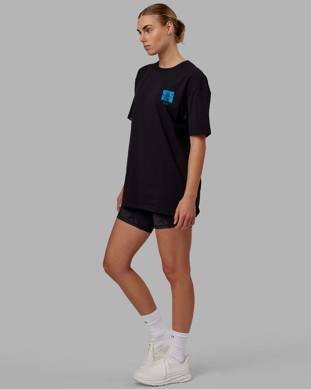 Woman wearing Unisex Party Pace FLXCotton Oversize Tee - Black-Blue  Edit alt text