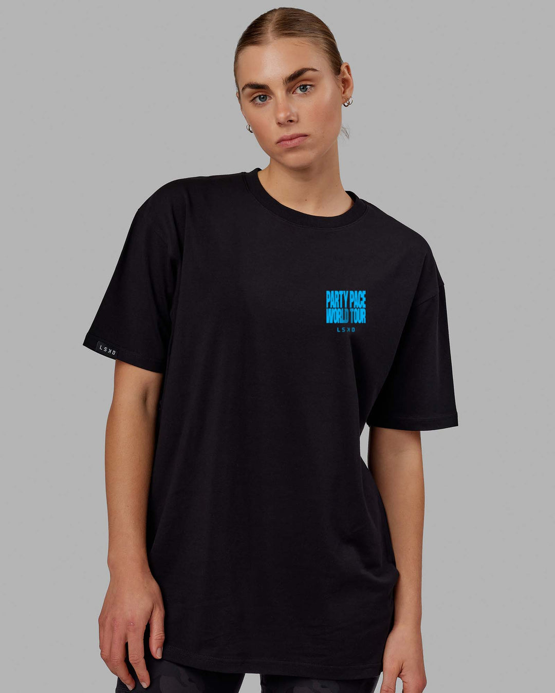 Woman wearing Unisex Party Pace FLXCotton Oversize Tee - Black-Blue  Edit alt text