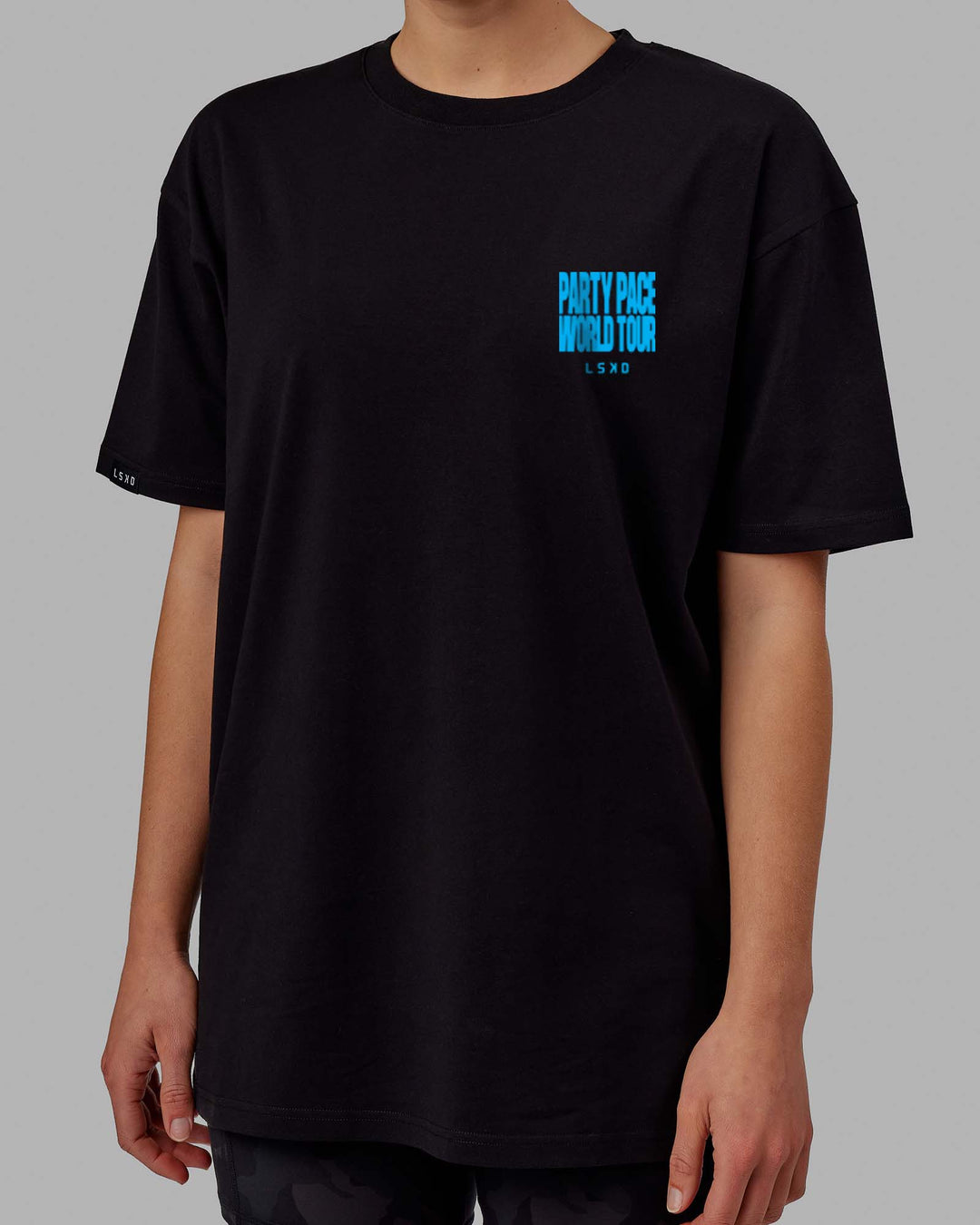 Woman wearing Unisex Party Pace FLXCotton Oversize Tee - Black-Blue  Edit alt text