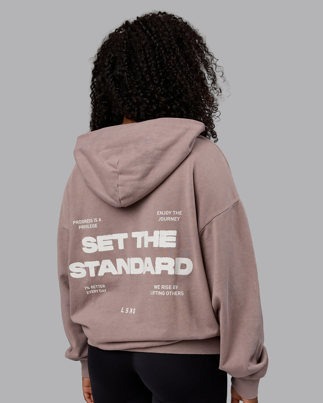 Woman wearing Unisex Washed Set the Standard Hoodie Oversize - Greyish Purple-Off White