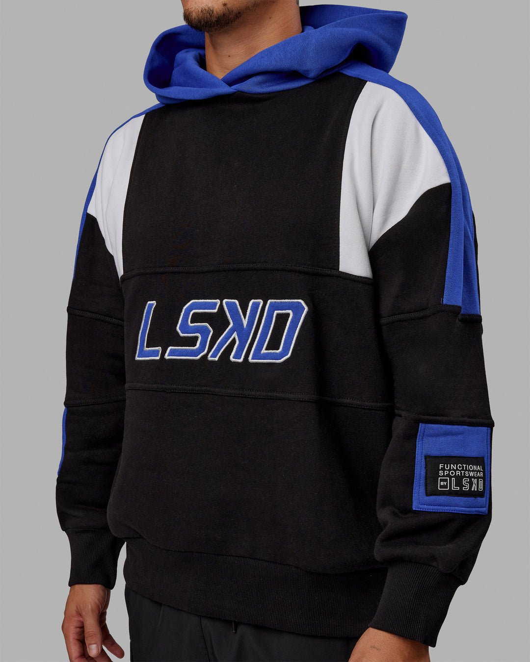 Man wearing Unisex Slam Hoodie Oversize - Black-Power Cobalt