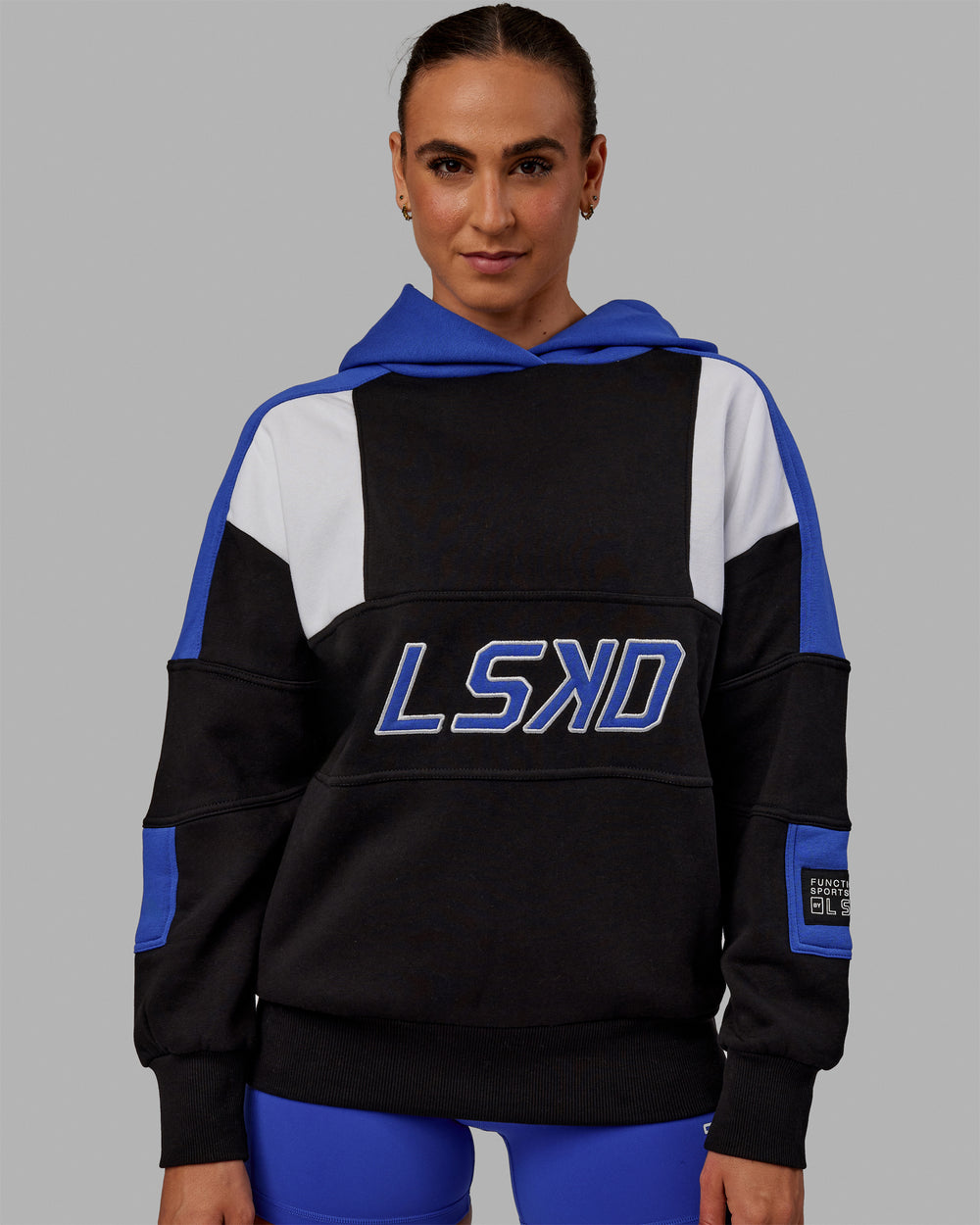 Woman wearing Unisex Slam Hoodie Oversize - Black-Power Cobalt