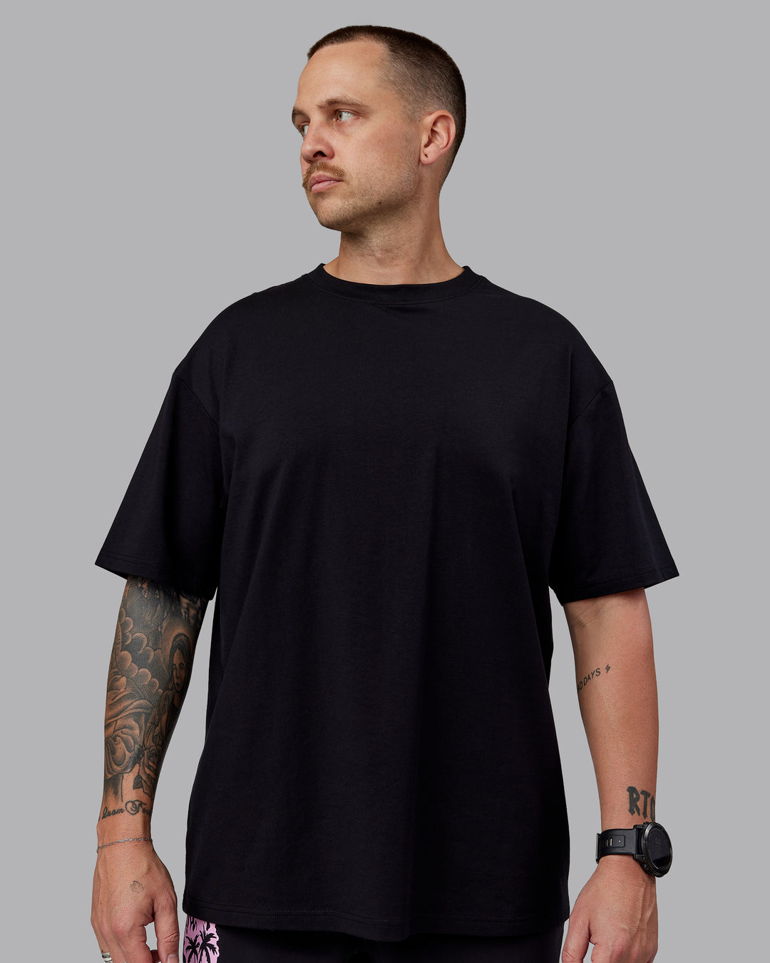 Man wearing Unisex So Cal 24 FLXCotton Tee Oversize - Black-Beacon Orange