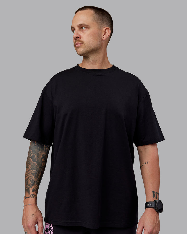 Man wearing Unisex So Cal 24 FLXCotton Tee Oversize - Black-Beacon Orange
