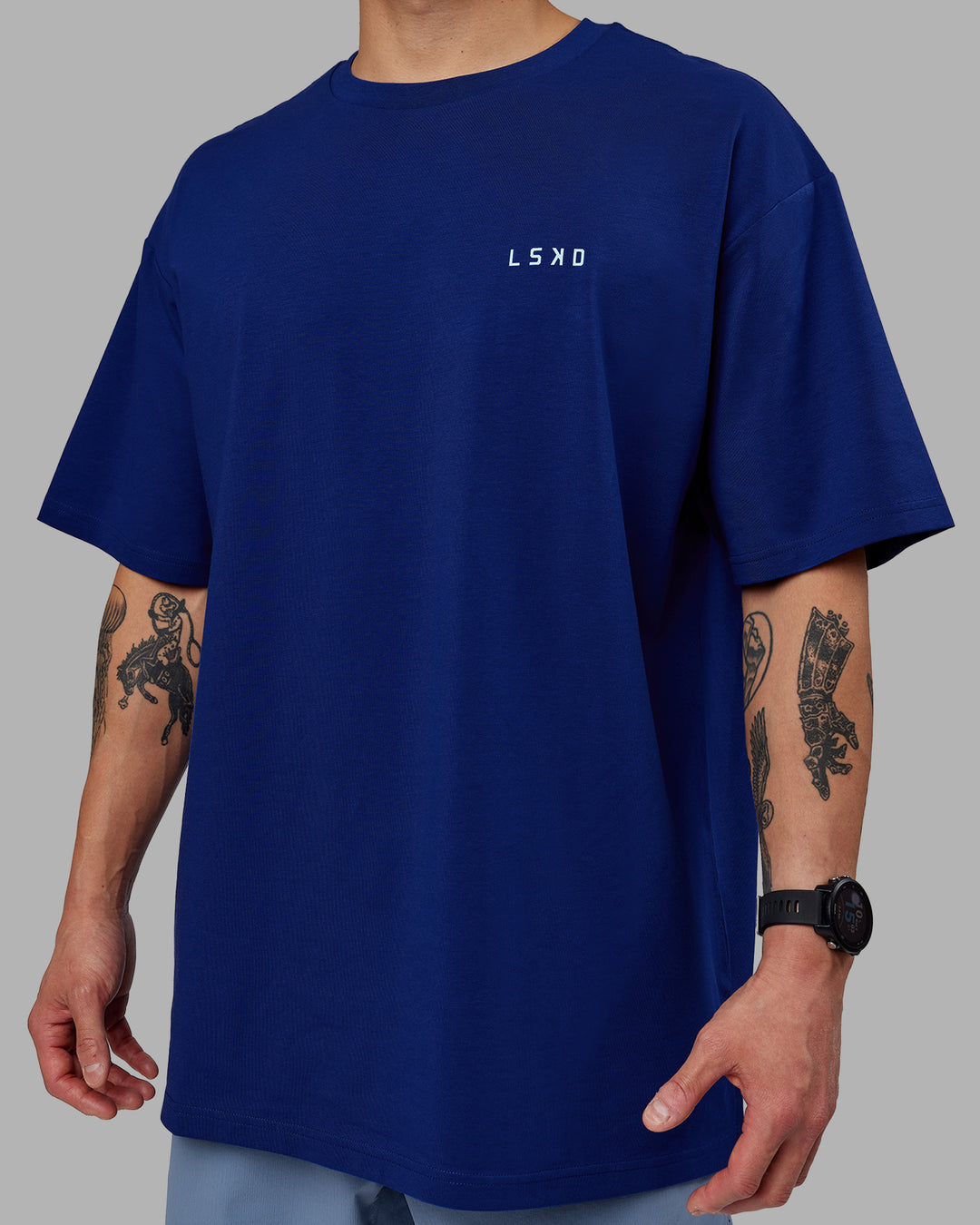 Man wearing Unisex Strike Through FLXCotton Tee Oversize - Midnight Blue-Glacial Blue