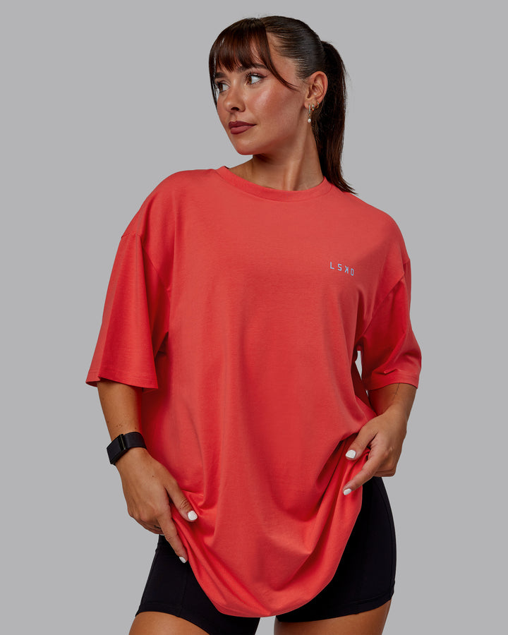 Woman wearing Unisex Strike Through FLXCotton Tee Oversize - Cayenne-Glacial Blue
