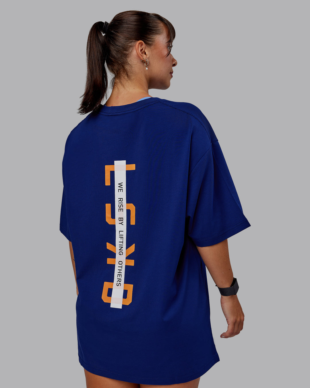 Woman wearing Unisex Strike Through FLXCotton Tee Oversize - Midnight Blue-Vibrant Orange