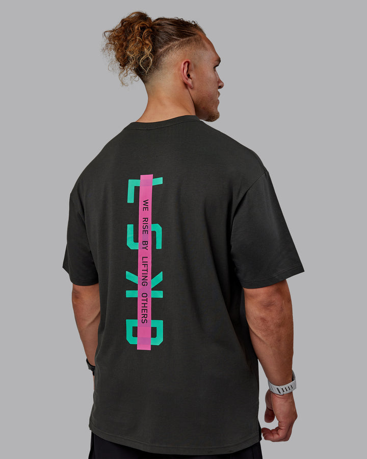 Man wearing Unisex Strike Through FLXCotton Tee Oversize - Pirate Black-Impact Green
