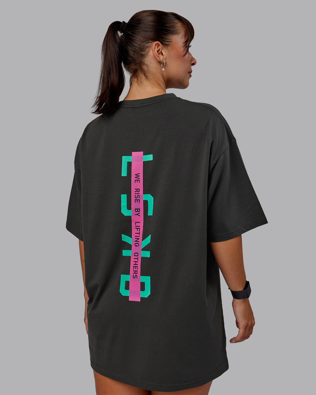 Woman wearing Unisex Strike Through FLXCotton Tee Oversize - Pirate Black-Impact Green