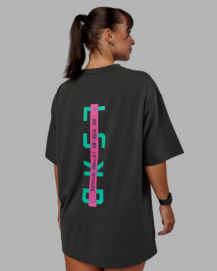 Woman wearing Unisex Strike Through FLXCotton Tee Oversize - Pirate Black-Impact Green
