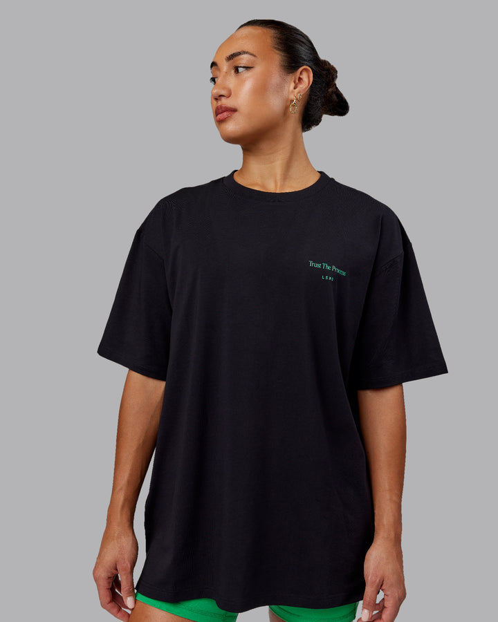 Woman wearing Unisex Trust The Process 2.0 FLXCotton Tee Oversize - Black-Impact Green
