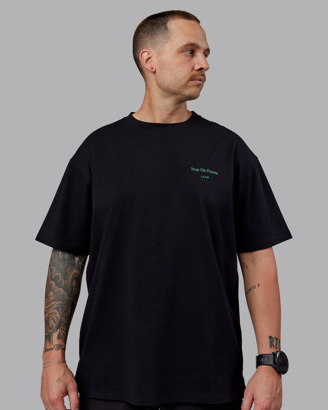 Man wearing Unisex Trust The Process 2.0 FLXCotton Tee Oversize - Black-Impact Green