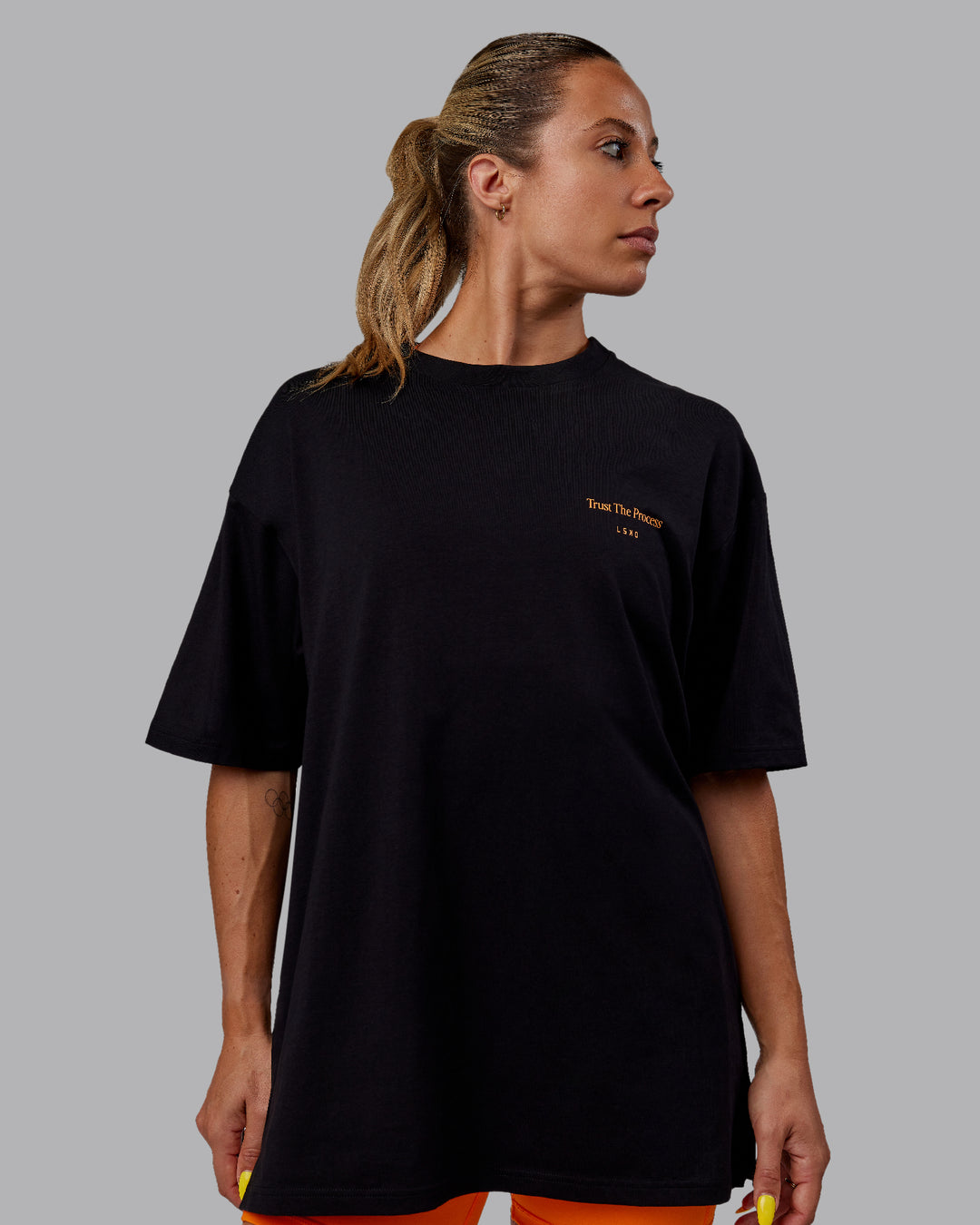 Woman wearing Unisex Trust The Process 2.0 FLXCotton Tee Oversize - Black-Vibrant Orange