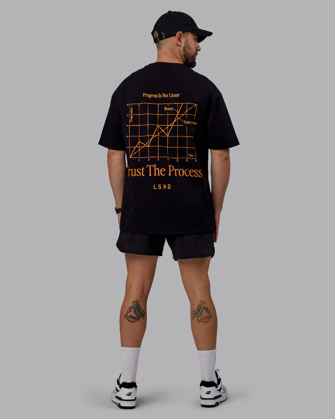 Man wearing Unisex Trust The Process 2.0 FLXCotton Tee Oversize - Black-Vibrant Orange