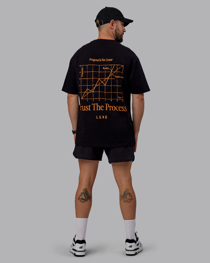 Man wearing Unisex Trust The Process 2.0 FLXCotton Tee Oversize - Black-Vibrant Orange
