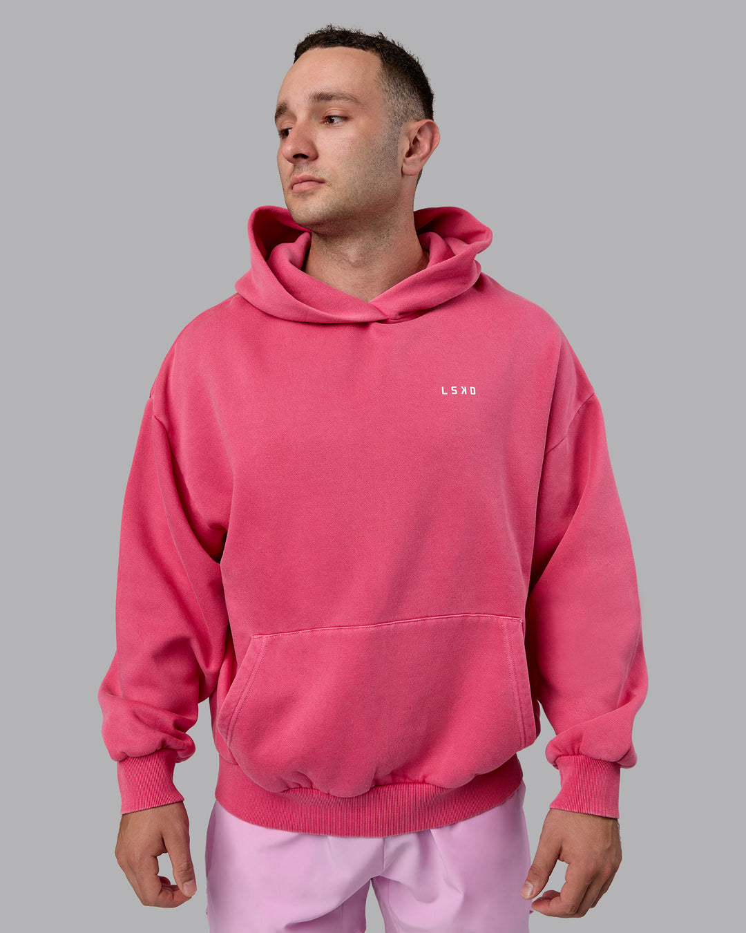 Man wearing Unisex Washed Empower Hoodie Oversize - Berry Pink-Pastel Orchid