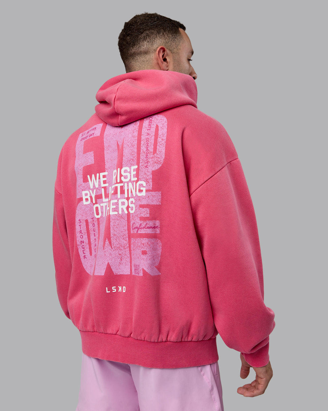 Man wearing Unisex Washed Empower Hoodie Oversize - Berry Pink-Pastel Orchid